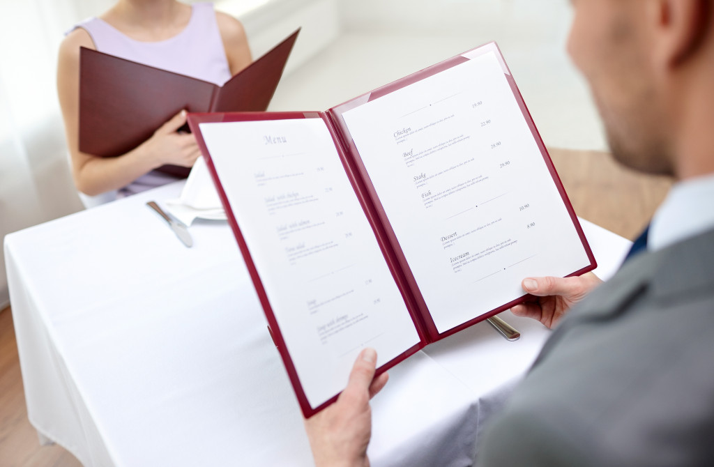 A couple with menu choosing dishes at a restaurant