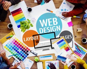 People working aroung a table with colorful papers and Web Design and related concepts in the middle