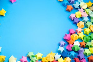 colorful lucky paper stars on a blue surface